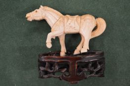 A carving of a horse on stand.