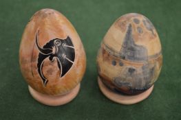 Two decorative hardstone eggs and on stands.