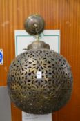 An eastern style pierced metal lampshade.