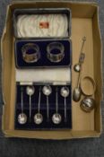 A cased set of silver coffee spoons, a cased pair of napkin rings etc.