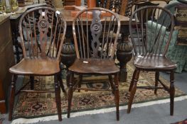 Three 19th century Windsor single dining chairs, two with pierced and carved back splats.