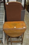 An oak drop leaf gate leg table and a folding screen.