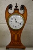 An Edwardian inlaid mahogany mantle clock.