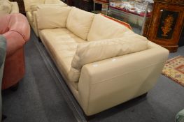A Roche Bobois cream leather three seater settee.