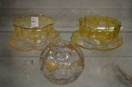 A pair of gilt decorated glass bowls and stands together with a similar bowl.
