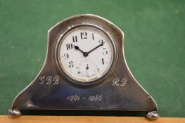 A silver desk clock.