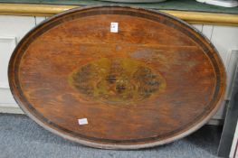 A 19th century oval mahogany tray inlaid with an armorial and crest (faults).