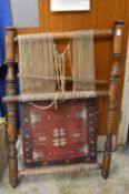 An unusual Persian loom showing a part woven rug.