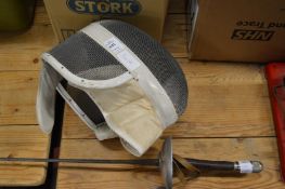 A fencing foil and helmet.