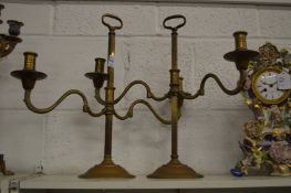 A pair of adjustable twin branch brass candlesticks.