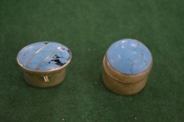 Two silver pill boxes.