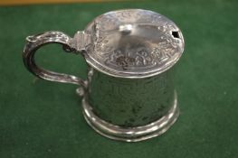 A silver drum shaped mustard pot with blue glass liner.