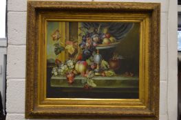 A still life of fruit in a bowl on a ledge, oil on canvas, in a decorative gilt frame.