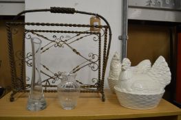 A magazine rack, two glasses vases and two chicken egg holders.