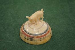 A model of a pig on a base.