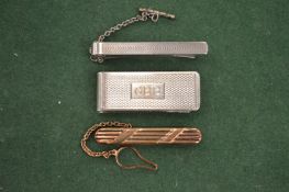 Two tie clips and a money clip.