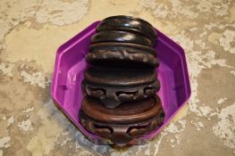 A quantity of Chinese wooden stands.