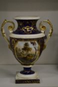 A 19th century Crown Derby urn shaped twin handled pedestal vase, rich blue ground with gilt