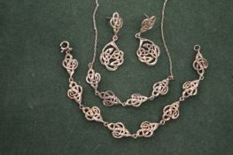 A silver bracelet, earrings and necklace.
