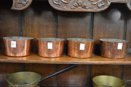 A set of four copper bowls.