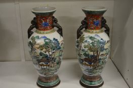 A pair of Chinese baluster shaped vases painted with landscapes.
