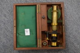 A mahogany cased brass microscope.