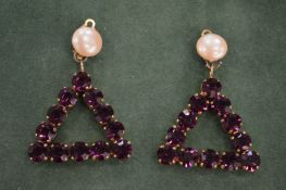 A pair of Lisa Jenkins designer triangle shaped earrings.