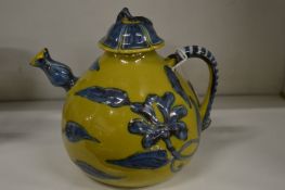 A Chinese yellow ground pottery teapot and cover.