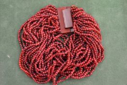 A Gerda Lynggaard horn necklace in white bag.