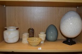Alabaster jars and other decorative items.