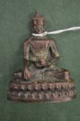 A small cast metal Buddha.