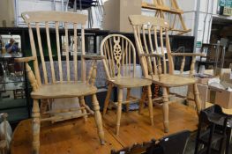 A pair of Victorian style broad arm Windsor chairs and a wheel back chair.