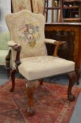 A good George III style mahogany framed open armchair with needlework upholstered back and seat on