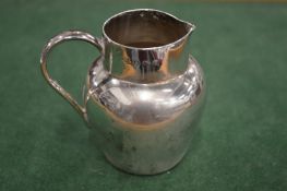 A small silver jug.