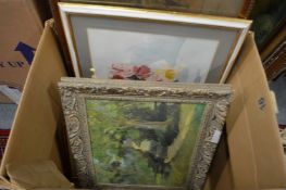 A box of paintings and prints.