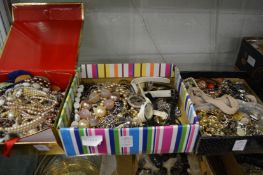 Three boxes of costume jewellery.