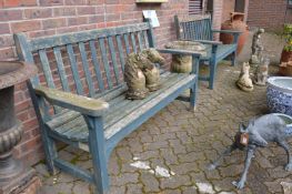 A pair of painted garden benches.