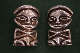 A pair of African figure earrings.