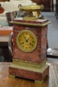 A good Regency rouge marble and ormolu mantle clock with urn finial.