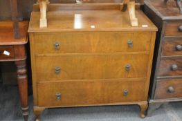 A walnut three drawer chest.