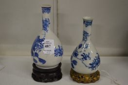 Two small Chinese blue and white bottle vases on stands.