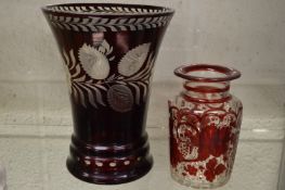 A ruby tinted cut glass vase and similar jar.