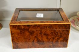 A burr wood and glass topped jewellery box.
