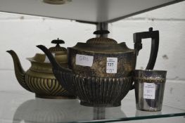 Two plated teapots and a beaker.