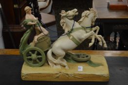 A Royal Dux group depicting a Roman chariot being pulled by two horses.