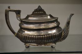 A silver teapot.