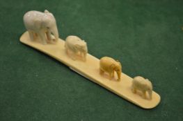 A carved group of four elephants.