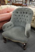 A Victorian button back armchair.