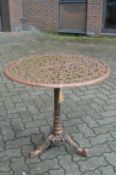 A cast metal circular garden table.