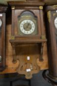 A walnut cased drop dial wall clock.